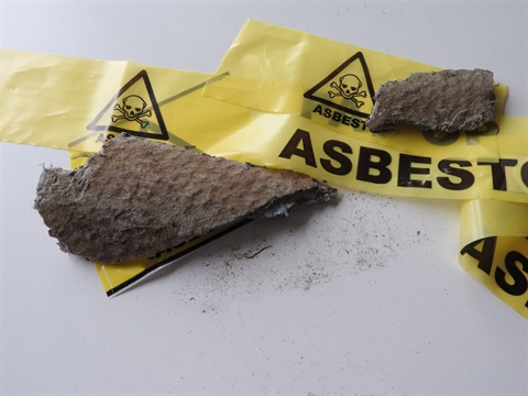 A piece of asbestos wrapped in yellow tape.