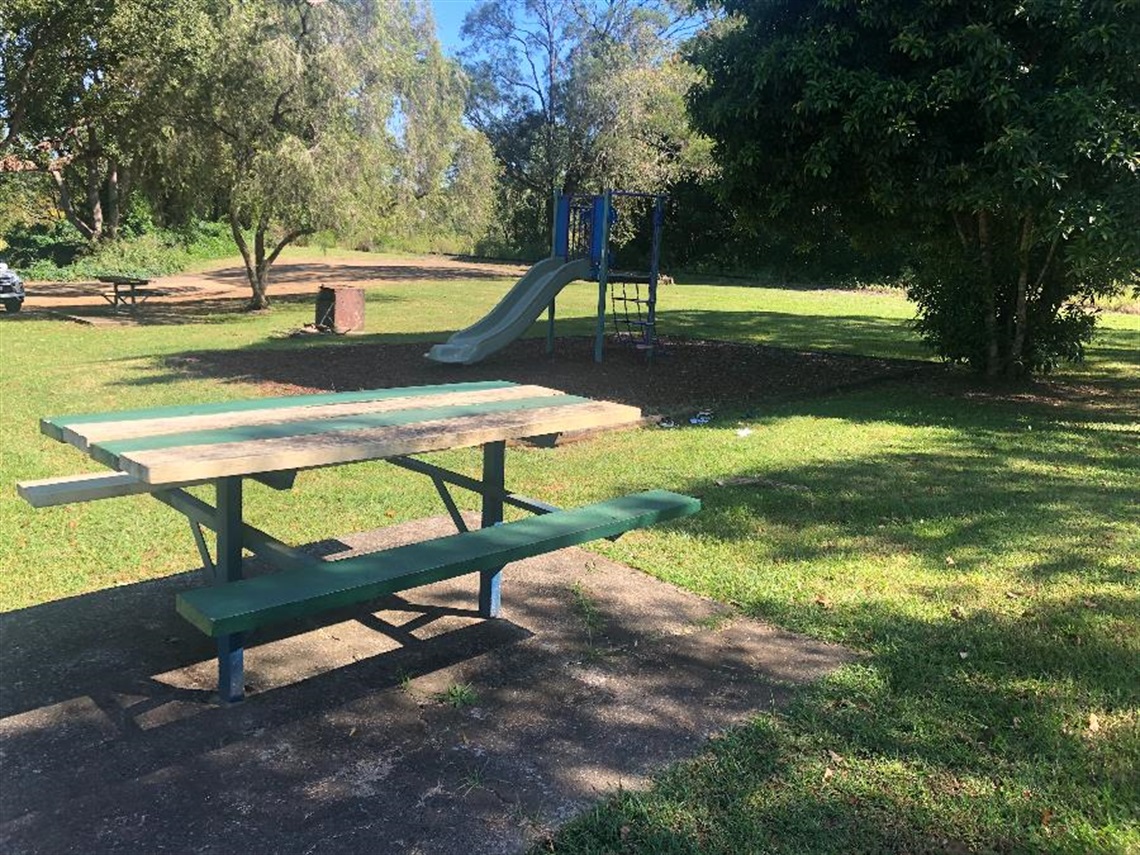 The picnic table and playground at Eltham Centenary Park.