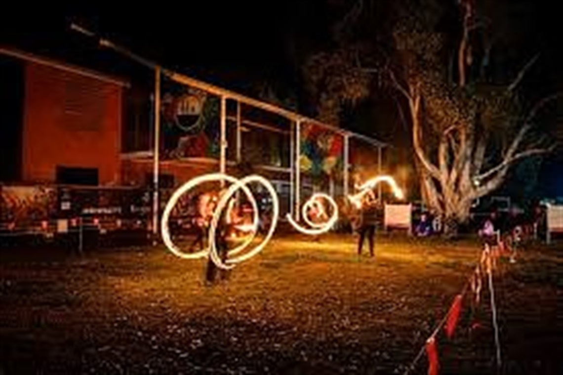 people twirling fire sticks
