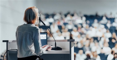 A woman speaks at a workshop.