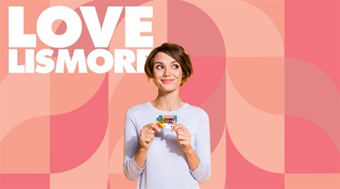 A woman holding the Loving Local Lismore Gift Card.