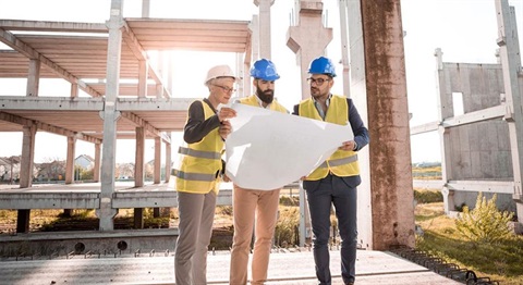 Building developers look over building plans.