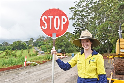 A council worker holding a stop sign.