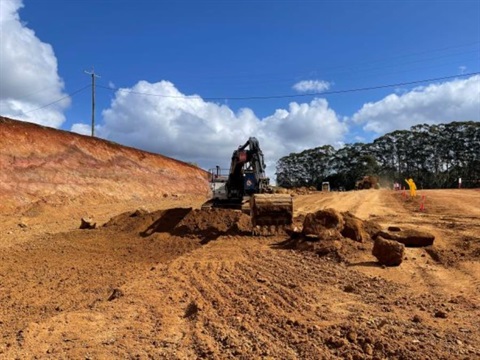 A bulldozer moving dirt on a residential devleopment.