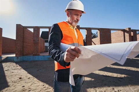 A building certifier looking over building plans.