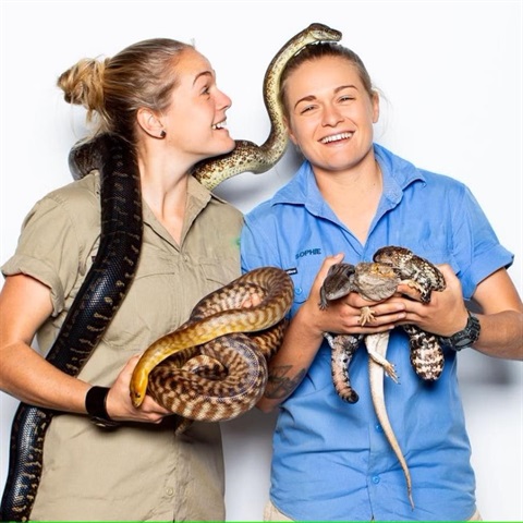 The Wildlife Twins holding reptiles.