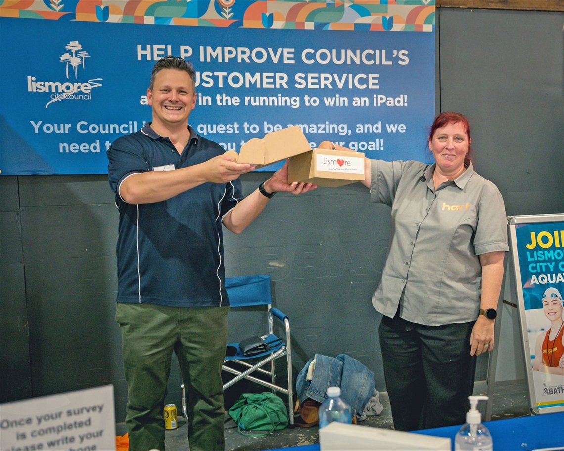 Council's Executive Officer for Customer Strategy, Don Wilson, at the 2023 Elders Back Lismore Show with a member of the community drawing the lucky winner of an ipad.