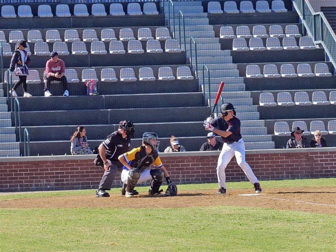 Baseball player about to hit the ball