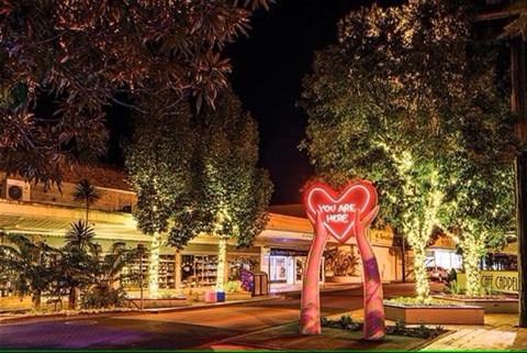 The You Are Here Lismore heart sculpture lit up at night in the Lismore CBD.