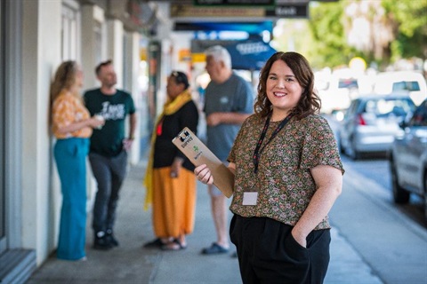 A council staff member conducting surveys on the street.