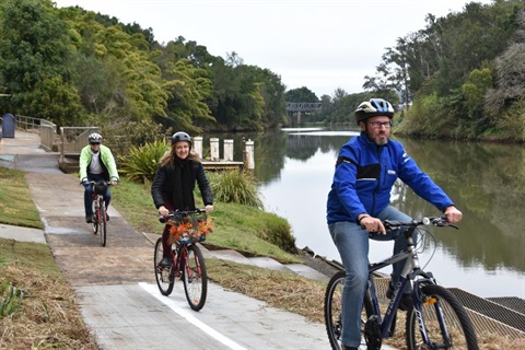 People cycling on a shared footpath along the Wilsons River.