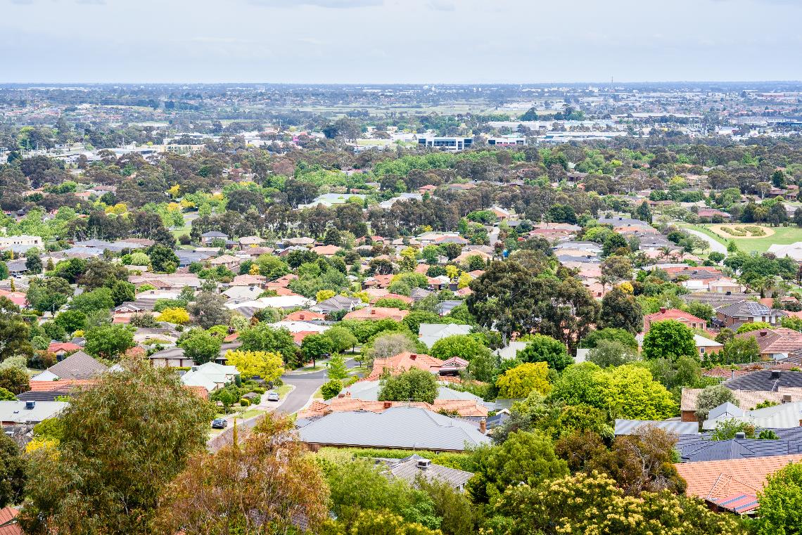 An aeriel photo of a suburb and housing rooftops.
