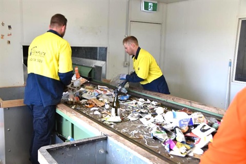 Council staff sorting through recyclable rubbish at the Materials Recovery Centre.