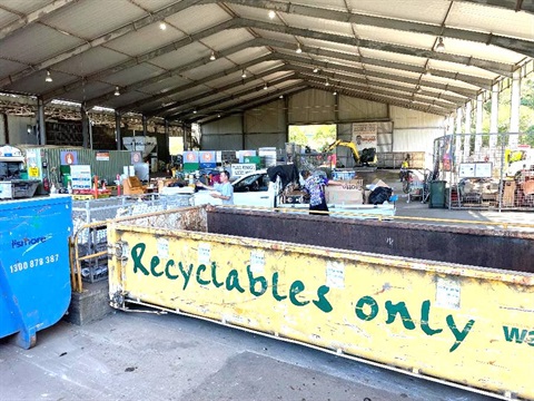 People sorting their waste at the Resource Recovery Facility.