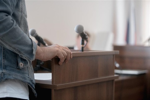 A person standing an a podium with a microphone.